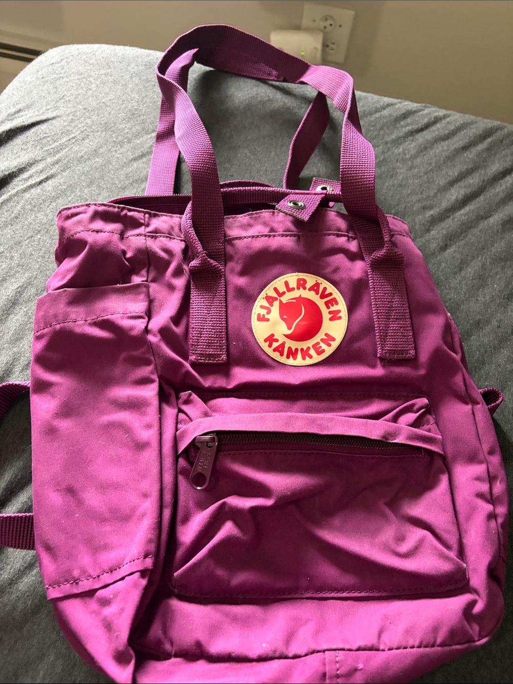 Fjallraven Kanken backpack in magenta/purple with red logo